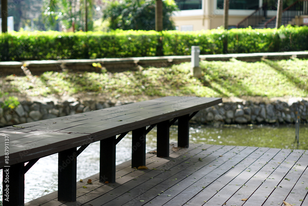 Long wood bench for rest and nature background Long wood bench for rest and nature background