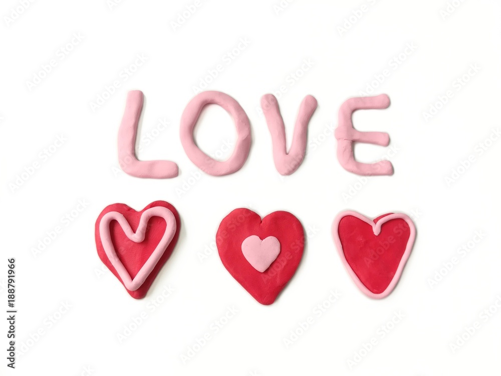 Pink and red plasticine clay dough made are beautiful variety hearts and love text on white background Pink and red plasticine clay dough made are beautiful variety hearts and love text on white background
