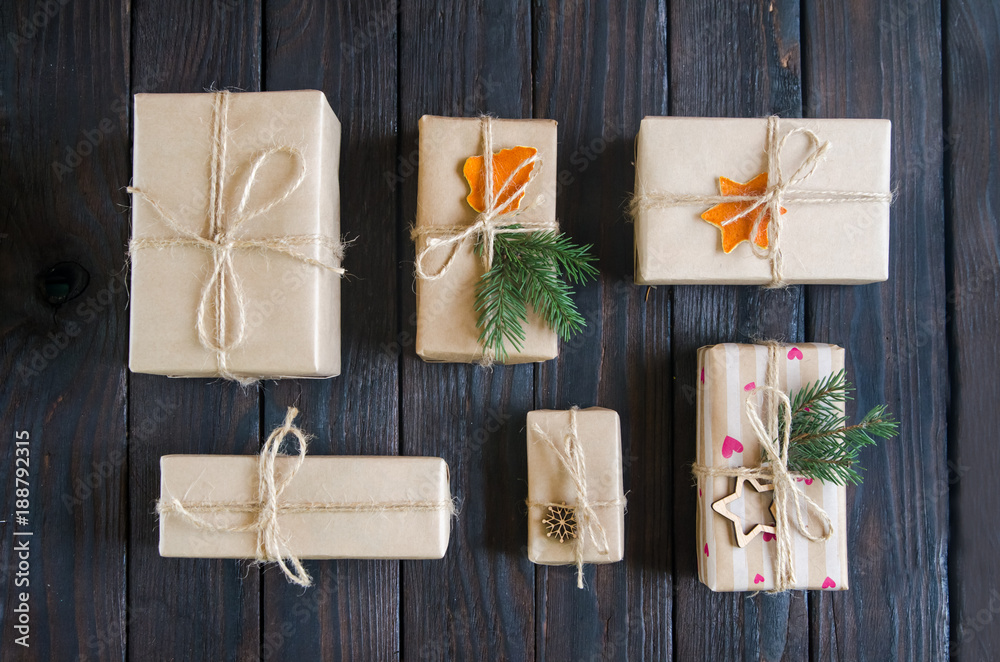 Christmas still life with gifts on a black wooden background with a Christmas tree. New Year gifts Christmas still life with gifts on a black wooden background with a Christmas tree. New Year gifts