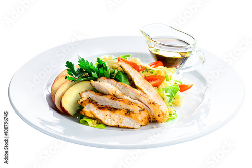 Roasted juicy pork steak with apples and soy sauce in a white plate isolated on white background
