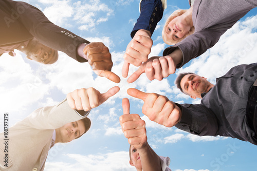 Group Of Businesspeople Gesturing Thumbs Up