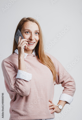 Happy woman phone talking at white studio background