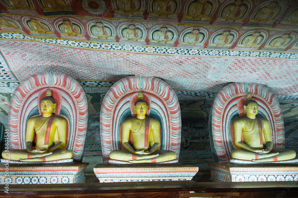Group of sitting Buddha statues in cave buddhist temple Group of sitting Buddha statues in cave buddhist temple