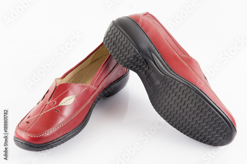 Female red leather shoe on white background, isolated product, footwear.