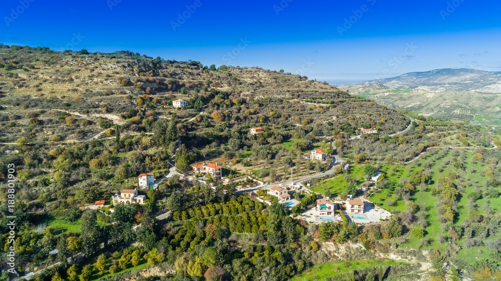 Aerial bird eye view of Miliou village hills and Akamas sea at Latchi, Paphos Cyprus. View of traditional ceramic tile roof houses near Ayii Anargyri monastery nature hotel spa from above.