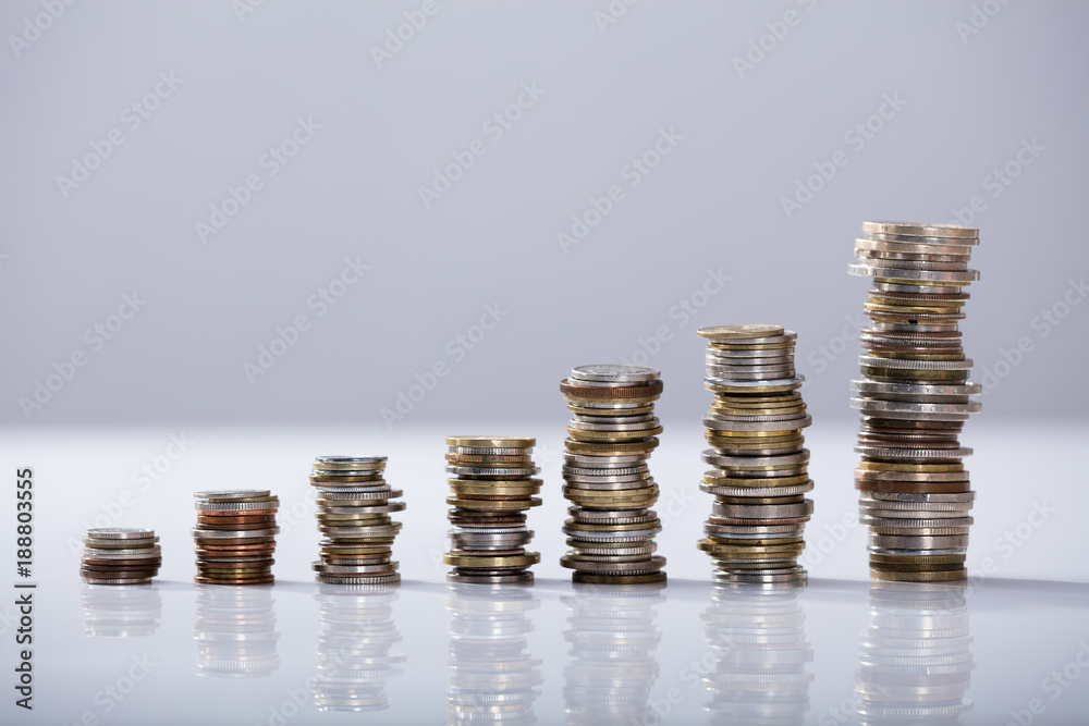 Stack Of Increasing Coins On Desk Stack Of Increasing Coins On Desk