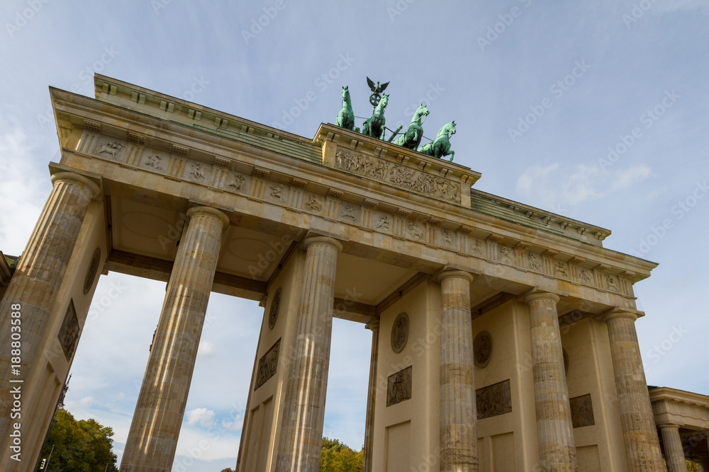Brandenburg Gate from angled below against a light blue sky