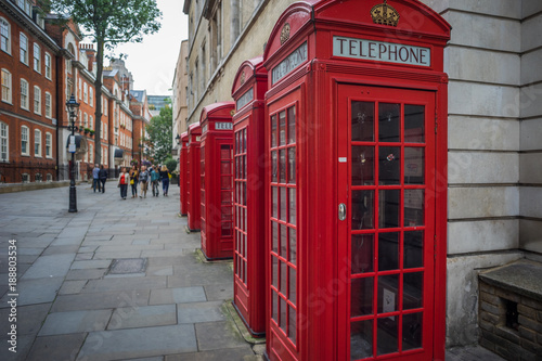Row of red phone telephone boxes in London © johannestoenne