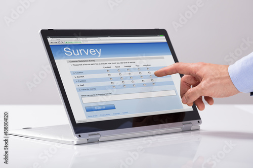 Businessman Filling Online Survey Form On Hybrid Laptop