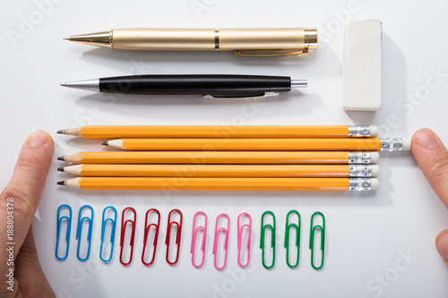 Person Arranging The Pencils On White Background