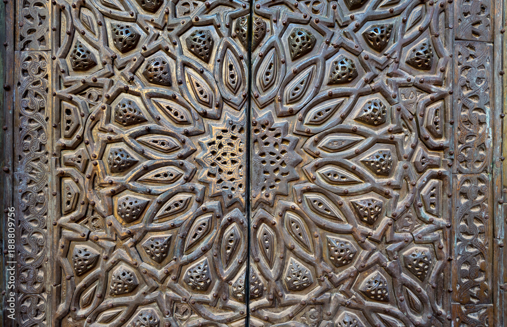 Ornaments of the bronze-plate ornate door of minbar of Al Sultan Hasan Mosque, historic public mosque located in Cairo, Egypt