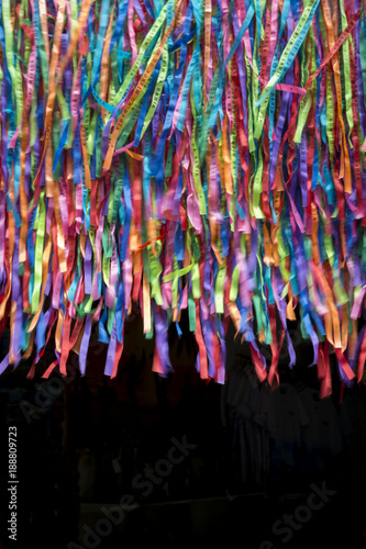 Colorful background of Brazilian wish ribbons, a famous souvenir from Salvador, Bahia, Brazil, in a dark doorway portal