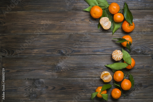 Fresh tangerine oranges on a wooden table. Peeled mandarin. Halves, slices and whole clementines closeup.