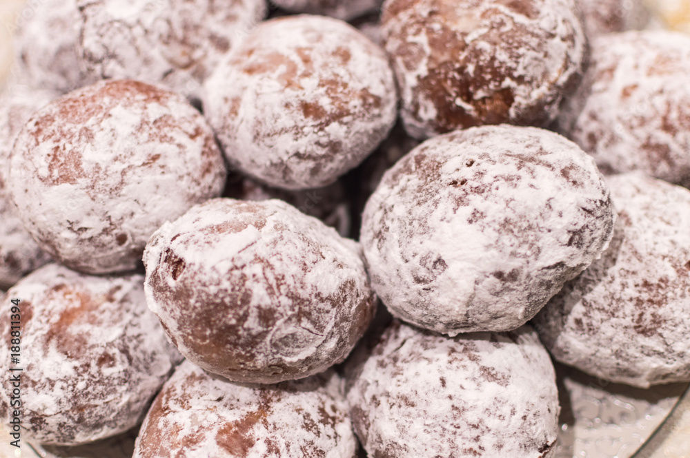 Fresh baked homemade donuts with powdered sugar on them - close up Fresh baked homemade donuts with powdered sugar on them - close up