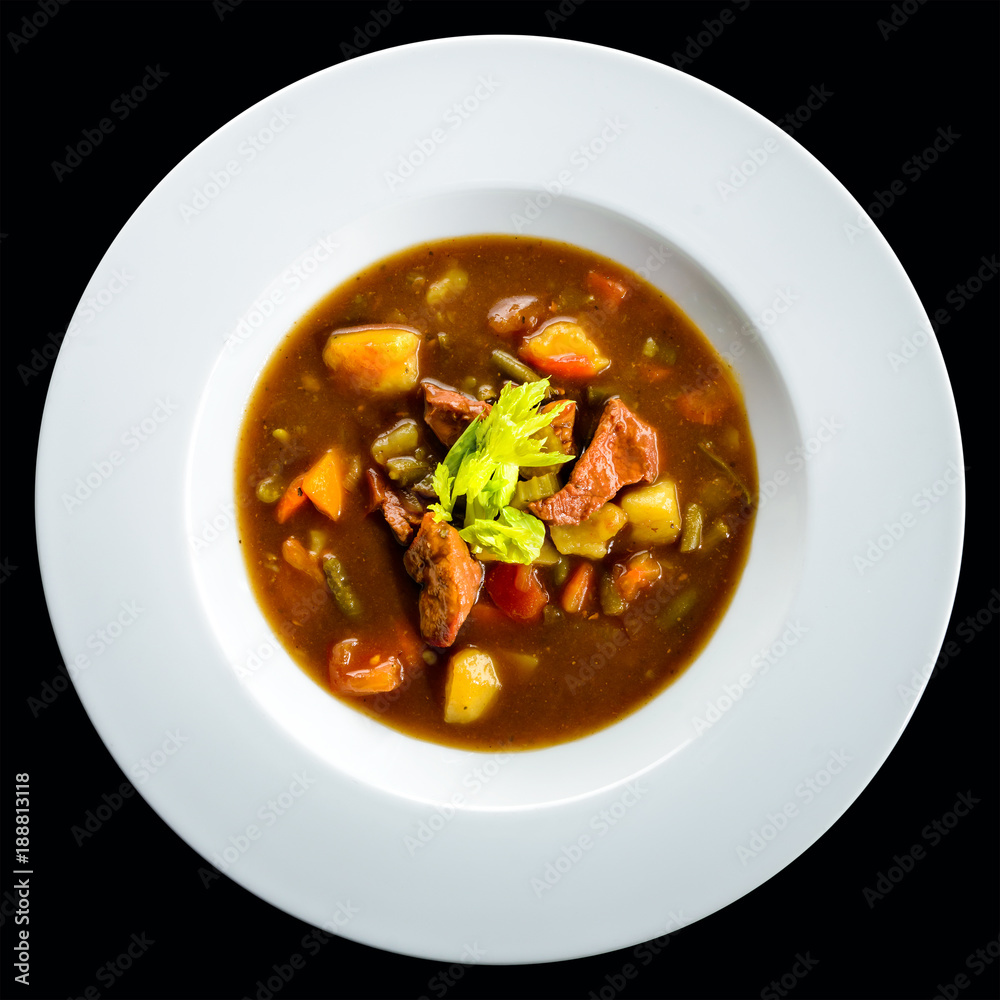 Traditional Italian cuisine. Tasty Hungarian goulash soup bograch in a white plate. Top view, flat lay Traditional Italian cuisine. Tasty Hungarian goulash soup bograch in a white plate. Top view, flat lay