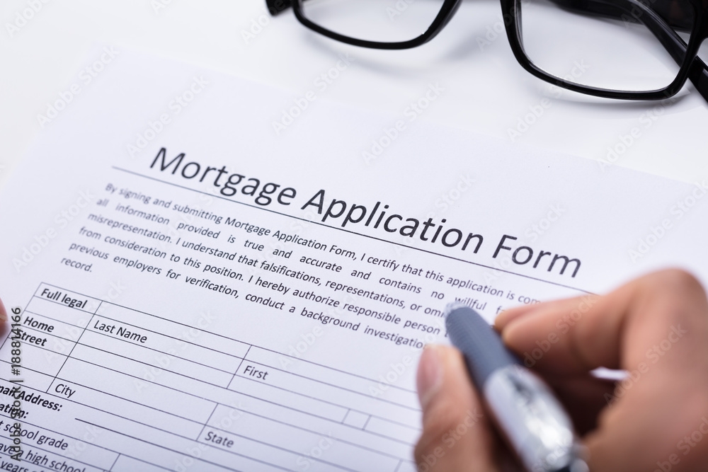 Human Hand Filling Mortgage Application Form Human Hand Filling Mortgage Application Form