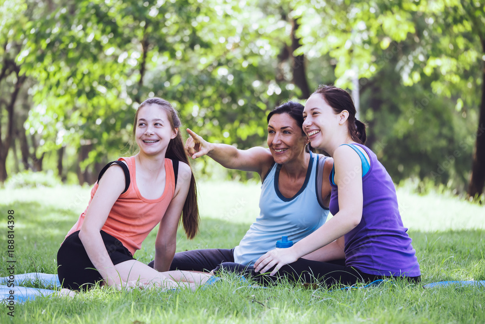 Activities in the family, mother and daughter relaxing in the park after practicing yoga. Activities in the family, mother and daughter relaxing in the park after practicing yoga.