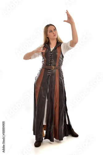 full length portrait of girl wearing brown fantasy costume. standing pose on white studio background. 