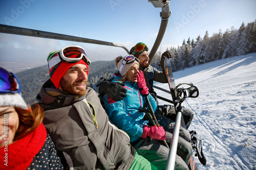 Skiers going to ski terrain with ski lift