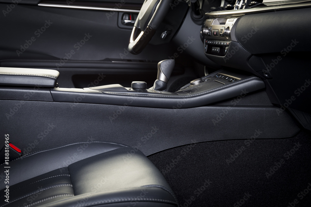 Dark luxury car Interior - steering wheel, shift lever and dashboard. Car interior luxury. Beige comfortable seats, steering wheel, dashboard, climate control, display.