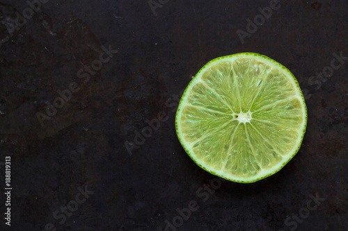 top view of citrus Fruit Lime slice on black background with copyspace