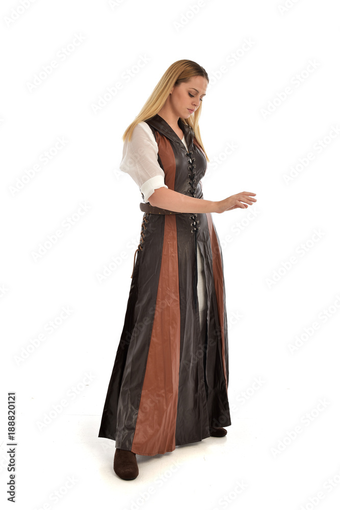 Fototapeta premium full length portrait of girl wearing brown fantasy costume. standing pose on white studio background. 