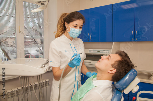 A woman doctor dentist in the office communicates with the patient. Stomatology. Medicine.