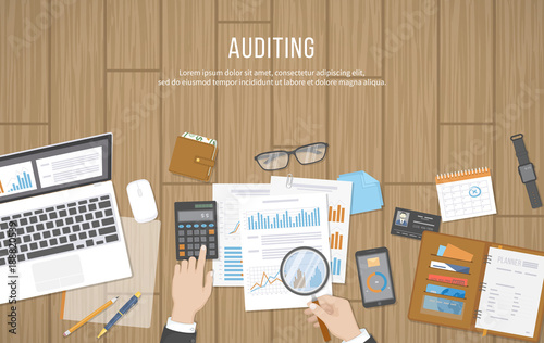 Auditing concepts. Auditor inspects assessing financial documents. Businessman hands with magnifying glass above documents, graphics, charts. Research, planning, accounting, analysis, calculation. 