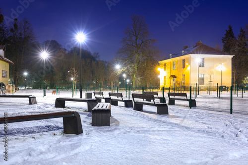Snowy winter at the playground at dusk, Poland