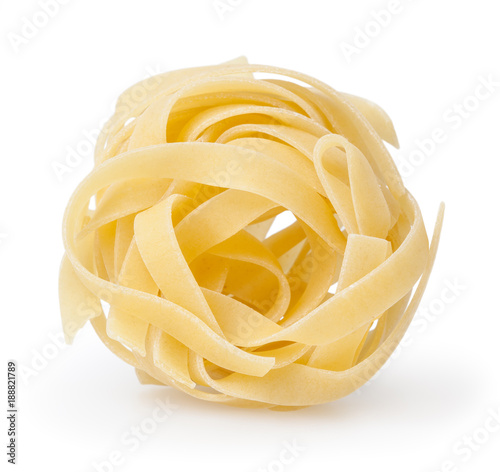 Uncooked nest of tagliatelle pasta isolated on white background with clipping path