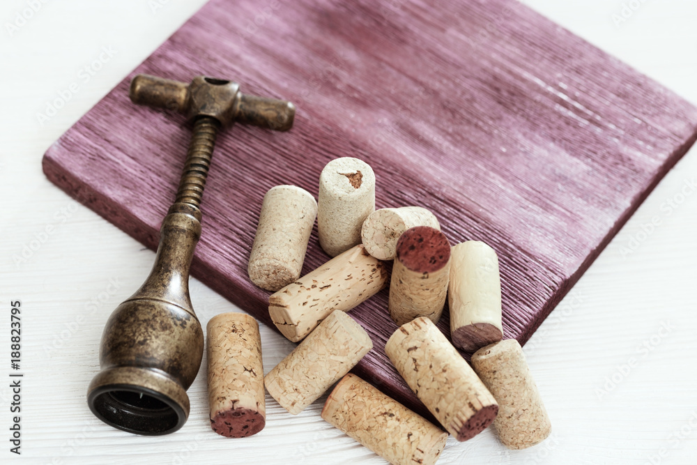 Wine corks with corkscrew on wooden surface. Background with cope space. Selective focus.