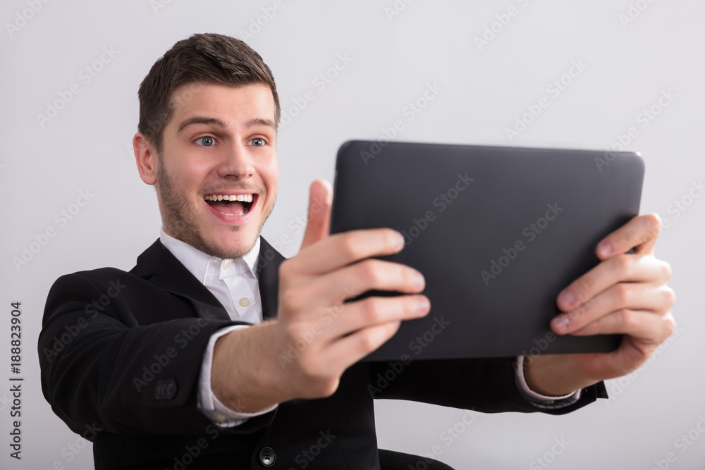 Happy Businessman Looking At Digital Tablet Happy Businessman Looking At Digital Tablet