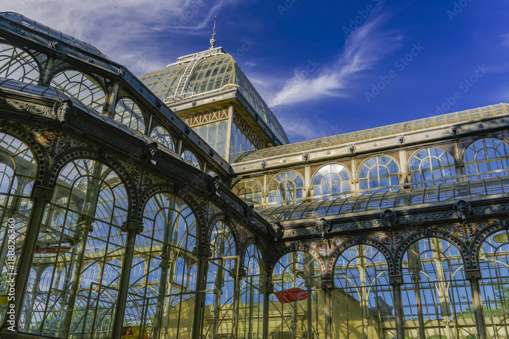 Fototapeta premium Madrid, Spain Palacio de Cristal iron framework external view detail. Day view of 1887 glass and metal structure of crystal palace at Park Retiro.