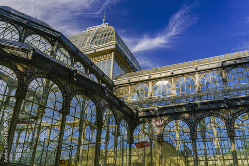 Madrid, Spain Palacio de Cristal iron framework external view detail.
Day view of 1887 glass and metal structure of crystal palace at Park Retiro.