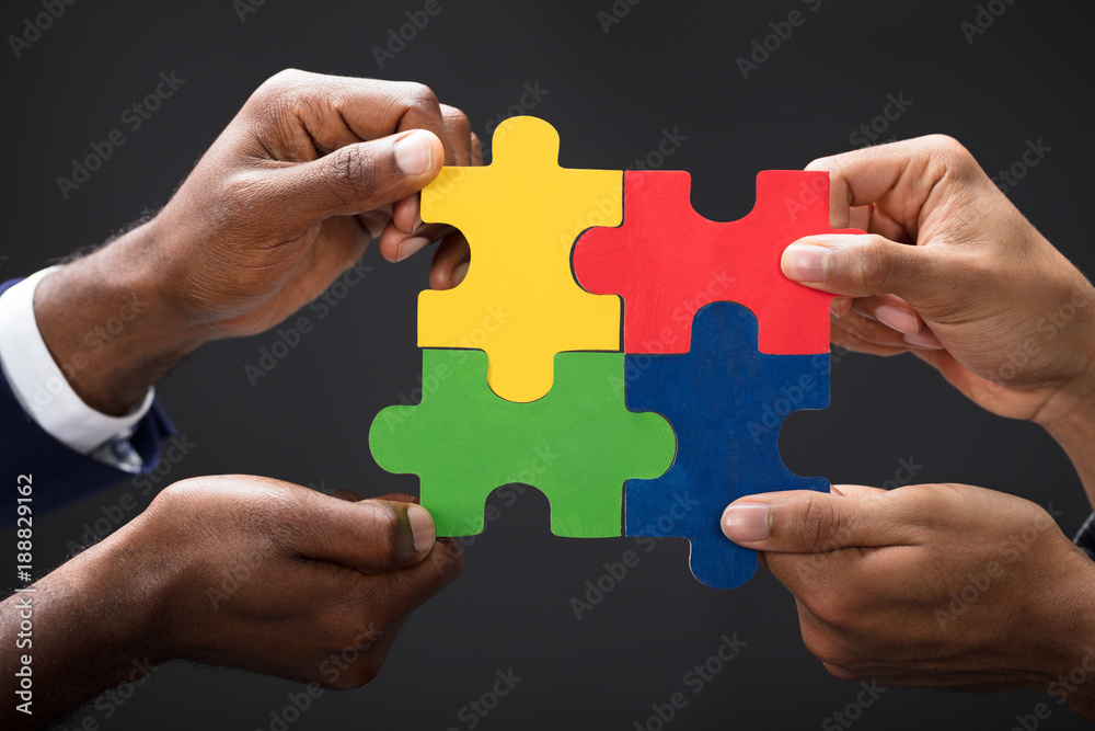 Hands Combining White Puzzle Pieces Hands Combining White Puzzle Pieces