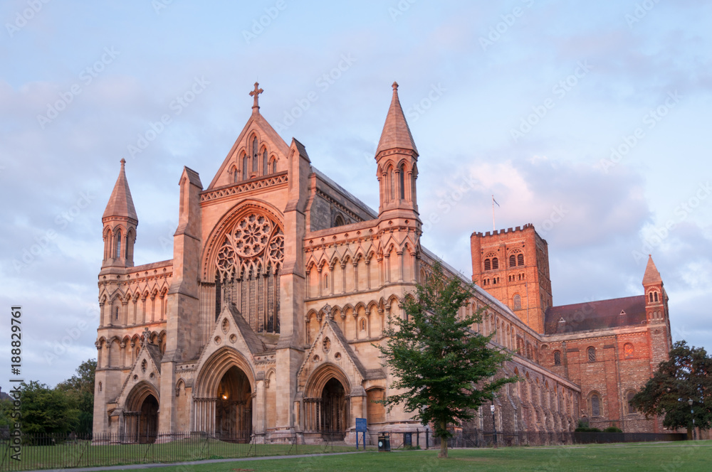 St Albans Cathedral at sunset with the end of the sunshine shining on the front doors