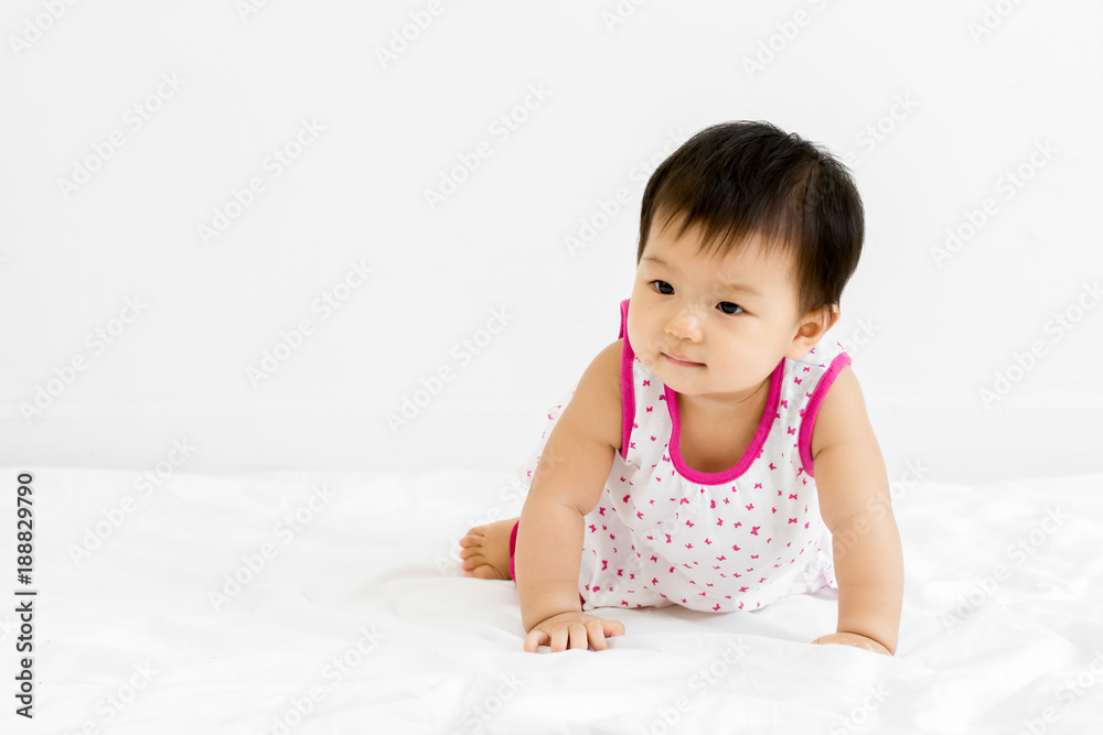 Portrait of adorable baby girl crawling on the bed, indoors Portrait of adorable baby girl crawling on the bed, indoors