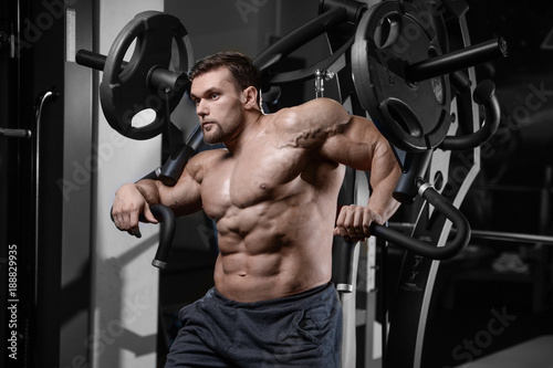 Brutal strong bodybuilder athletic men pumping up muscles with dumbbells.