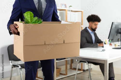 Businessperson Holding Belongings In Cardboard Box