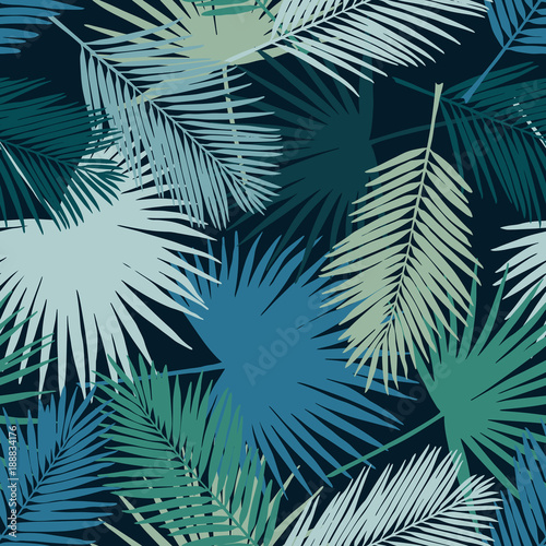 Seamless floral pattern with stylized fan and silk palm leaves. Jungle foliage  teal hues on navy blue background. Textile design.