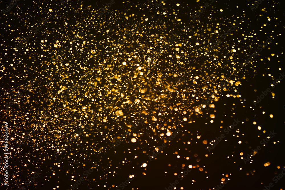 christmas gold sparkle glitter explosion dust particles background with bokeh, gold holiday happy new year and valentine day concept