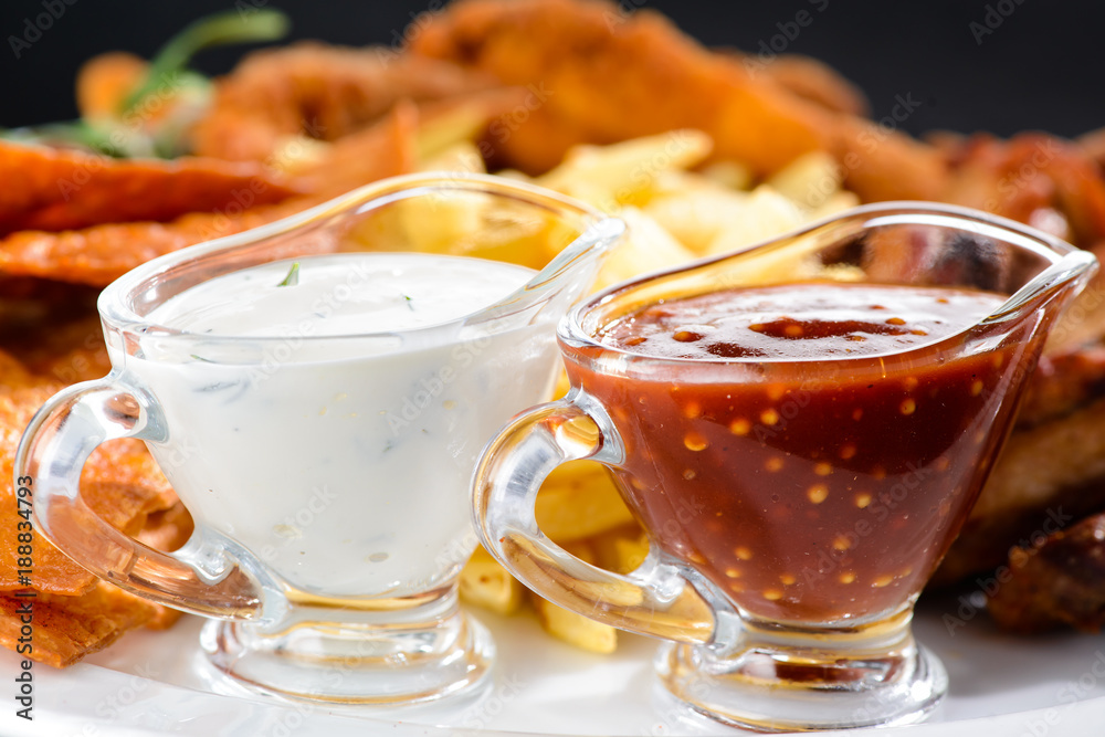 Food background with delicious fried potato and sauces, close-up Food background with delicious fried potato and sauces, close-up
