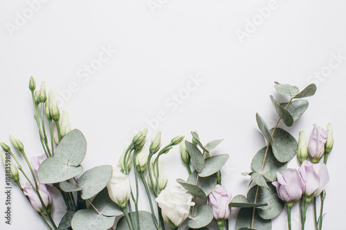 Creative arrangement pattern of box, eucalyptus and eustoma on a white background. Flat lay, top view. photo