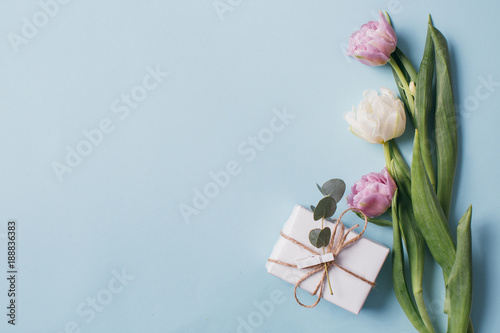 Fototapeta Naklejka Na Ścianę i Meble -  Mother's Day Composition: Violet and white tulips and a gift boxes on a blue background. Top view.Flat lay.