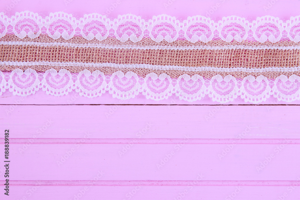 Burlap lace on pink wooden background Burlap lace on pink wooden background
