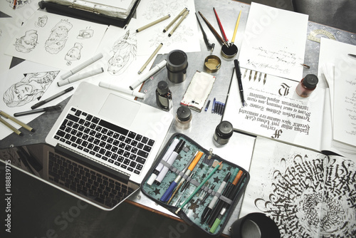 The Desk of artist, tattoo artists. Calligraphy. Top view sketches