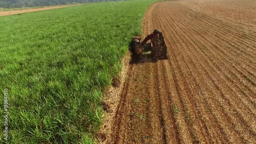 Over the top view of the truck running on the field doing the agriliming on the crops in the field. photo