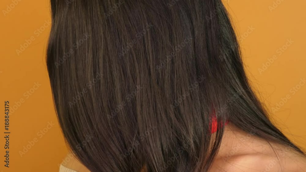 beautiful girl in chic hair on an orange background, sensitive lips, Asian-European appearance. beautiful girl in chic hair on an orange background, sensitive lips, Asian-European appearance.