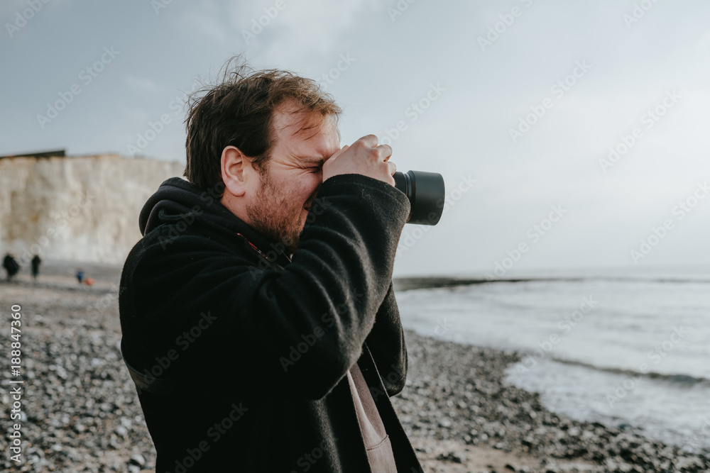 Male photographer taking picture of the landscapes with dslr