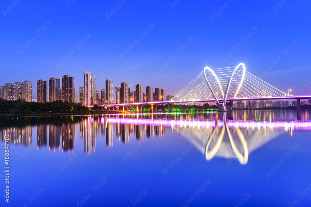 Obraz premium Modern bridge and skyscraper at dusk. Located in Shenyang, Liaoning, China.